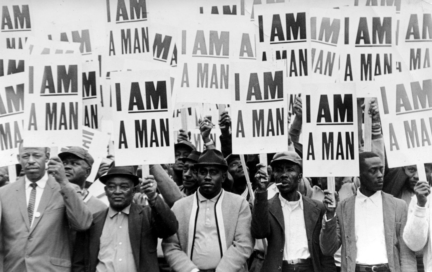 Striking sanitation workers holding signs reading "I am a man"