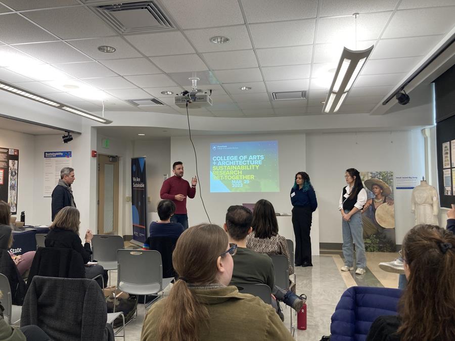 People presenting a Powerpoint presentation in front of a room of people