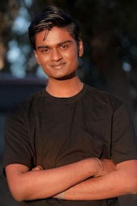 This is a photo of a man crossing his arms looking at the camera.